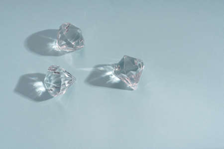 Three shiny brilliants stone on blue backgroundの写真素材