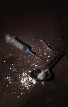 Dirty Syringe and spoon on the floor used to inject drugs with copy spaceの写真素材