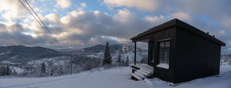 Hidden House on river side in snowy mountain forest in winterの写真素材