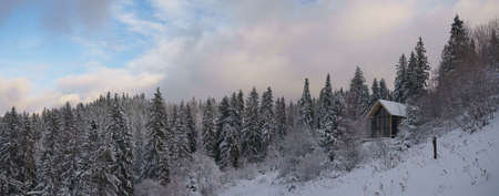 Hidden House on river side in snowy mountain forest in winterの写真素材