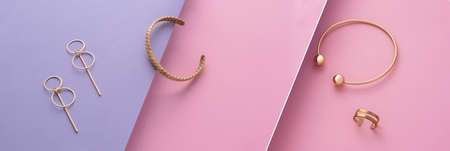 Elegance modern design jewelries set on pink and violet colors backgroundの写真素材