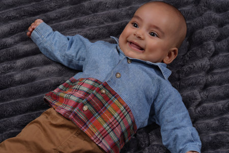 Cute baby boy wearing jeans shirt laughingの写真素材