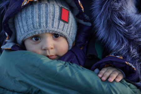 Portrait of an infant boy in warm winter clothesの写真素材