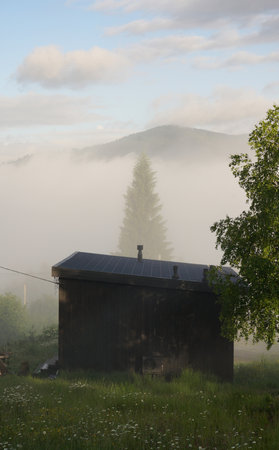 Tiny cabin above the clouds in Carpathian mountains in Ukraine with copy spaceの写真素材