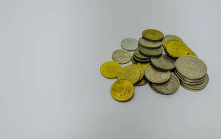 gold and silver money in stack at isolated white backgroundの写真素材