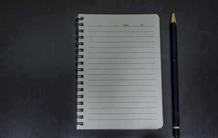 pencil and notebook on isolated black backgroundの写真素材