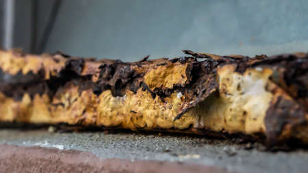 Close up view of the old rusty window fence. Damaged, broken and rotted of fence metal. Painting...