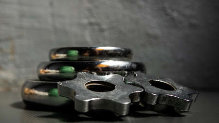 Metal dumbbell equipment with wall background. Use for fitness and healthy training purposes. Suitable to use for wallpaper. Dumbbell weight is stack together on the floor.の写真素材