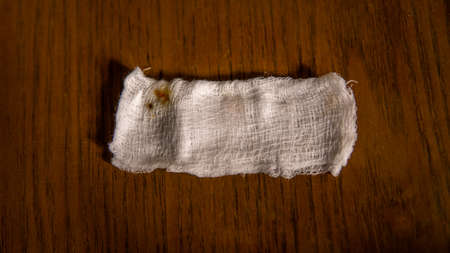 Blood stain from wound infection on the white bandage on the table.の写真素材