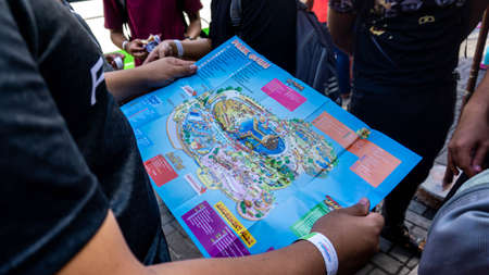 Subang Jaya, Malaysia - November 28, 2019: A group of tourist looking at the park guide map of...