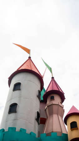 Castle tower with mini flag at the peak and white sky as background at Sunway Lagoon theme park in...