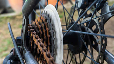 Close up view of the mountain bike rusty sprocket with gear and chain at the back tyre of bicycle...