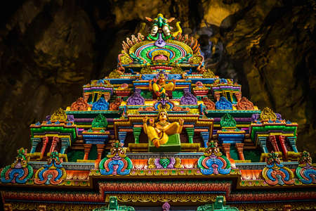 Gombak, Malaysia - January 4, 2020: Beautiful and colorful architectural building inside the Batu Caves. Statue of Hindu God in Batu caves Indian Temple, Kuala Lumpur. Image contain bit out of focus.のeditorial素材