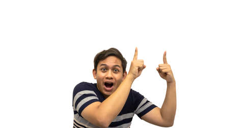 Wow and surprised face expression of young Asian Malay man in stripes t-shirt with hand pointing...