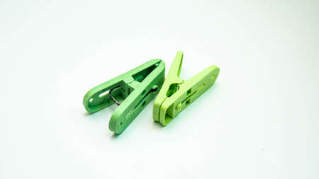 Closeup image of green clothespins or clothes pegs isolated on a white background.の写真素材