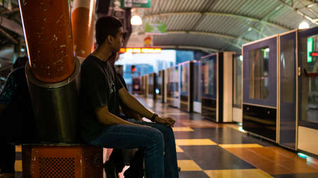 Kuala Lumpur, Malaysia - April 5, 2019: Unidentified boys waiting for the LRT train to stop at the Imbi station.のeditorial素材