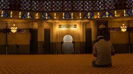 A Muslim man praying inside the Masjid Negara mosque.のeditorial素材