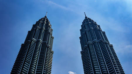 Kuala Lumpur, Malaysia - July 30, 2019: The low angle view of the Petronas Twin Towers or KLCC in the city with the clear blue sky during the day.のeditorial素材