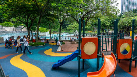 Kuala Lumpur, Malaysia - July 30, 2019: The kids playground beside the swimming pool at KLCC Park during the day.のeditorial素材