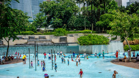 Kuala Lumpur, Malaysia - July 30, 2019: The view of the crowd of peoples at the KLCC Park Swimming Pool in Kuala Lumpur during the holidays.のeditorial素材