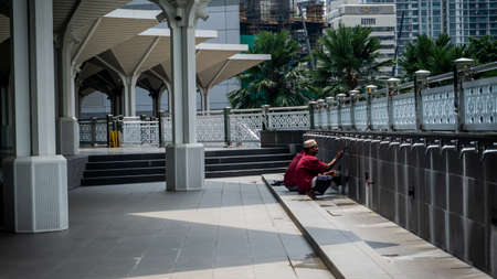 Kuala Lumpur, Malaysia - July 30, 2019: Unidentified muslim workers cleaning the water stain on the wall at KLCC Mosque or Masjid As-Syakirin in Kuala Lumpur during the day.のeditorial素材