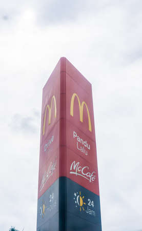 Cyberjaya, Malaysia - June 7, 2020: McDonald's 24 hours drive thru signboard tower with clear sky...