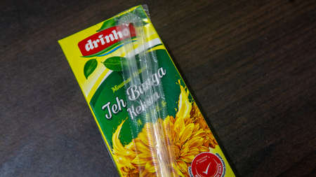 Kuala Lumpur, Malaysia - November 20, 2019: The close up view of the Drinho Botanical Beverage Chrysanthemum Tea packet drinks on wooden backgrounds. Selective focus on foregrounds.のeditorial素材