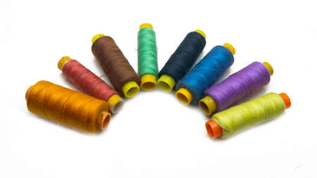 A various colors of sewing thread roll on an isolated white background. Selective focus on foreground.の写真素材