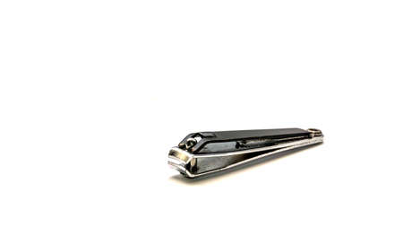 Black metal nail clipper on isolated white background. Hygiene equipment.の写真素材