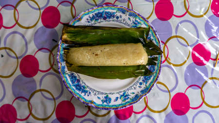 Pulut Panggang, a Malay traditional dessert on plate grilled glutinous rice wrapped in banana leaf...