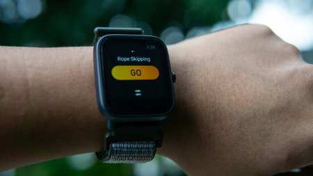 Close up view of man wearing a smartwatch to record rope skipping exercise on the wrist. It is a...