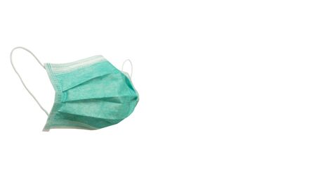 Green protection mask  die cut    on white background, concept for aviod the Covid 2019 virus symptoms pandemic, medical and healthcareの写真素材