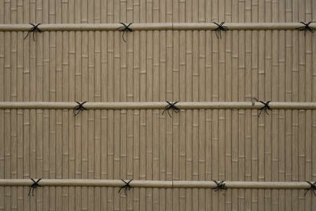 The gray color Bamboo wall and pattern of black rope bind on bamboo twigの写真素材