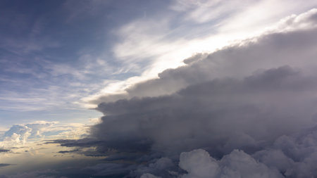Skyscape view from clear glass window seat of aircraft to cloudscape, traveling on white fluffy clouds and vivid blue sky and sunshineの写真素材