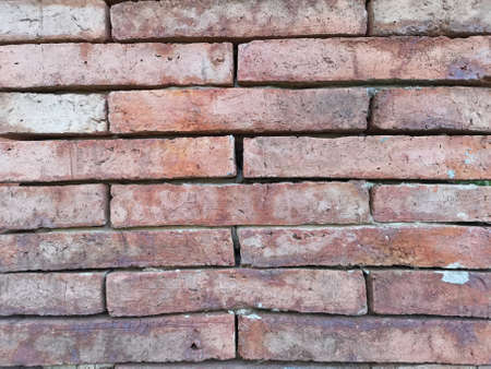 Wall of natural old brown color clay brick in background, closeup image