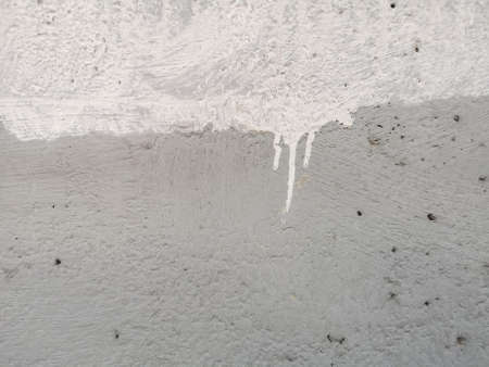 White color on grey color rough texture concrete wall skin with random small hole pattern cement...
