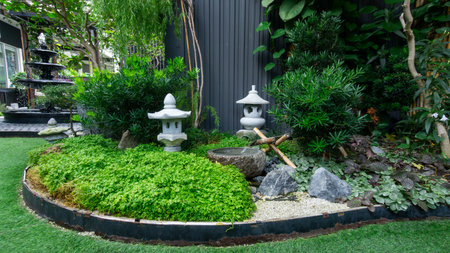 Japanese garden landscape wit green bush decorate with Japanese stone lantern and stone jarの写真素材