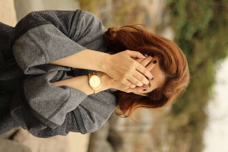 girl hiding face with handの写真素材