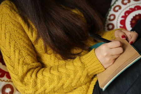 girl writing in a notebookの写真素材