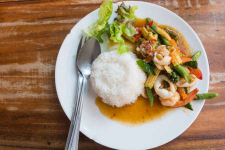 Thai food: stir-fried seafood with chili and herbs with riceの写真素材