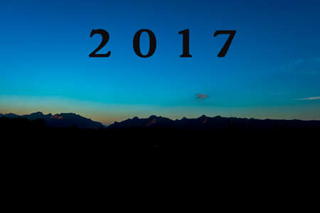 Beautiful sunset over the Doi Luang Mountains of Thailand/with a black mountain silhouetteの写真素材