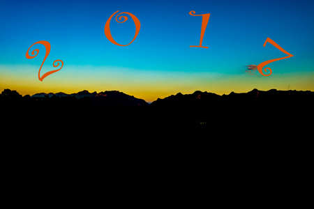 Beautiful sunset over the Doi Luang Mountains of Thailand/with a black mountain silhouetteの写真素材