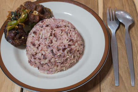 Thai food:Spicy stir-fried catfish served with rice berryの写真素材