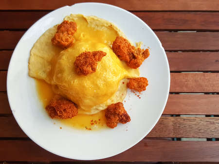 Thai food style:scrambled omlette eggs with spicy chicken on riceの写真素材