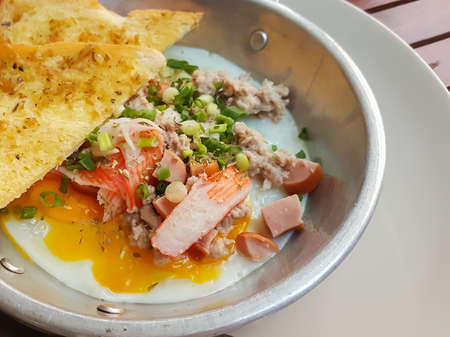 Breakfast thai food style:Close-up,pan-fried egg with pork and toppingsの写真素材