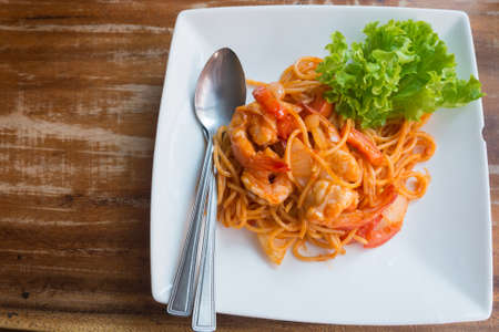 Close up stir fried spaghetti and prawn with tomato sauceの写真素材