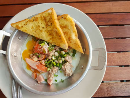 Breakfast thai food style:Close-up,pan-fried egg with pork and toppingsの写真素材