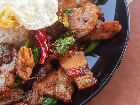 Close-up,Thai food:"Kao Pad Kra Prao"fried basil crispy pork serv with rice,process colorの写真素材