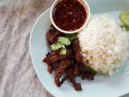 Thailand food style:"Kaow Moo Tod Nam Jim Jaw"Fried pork with rice served with spicy sauceの写真素材