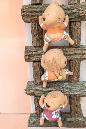 close-up,Three funny doll on a wooden ladder,process colorの写真素材